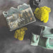 Obsidian Mist soap bar with packaging on a dark surface with moss-like decorations